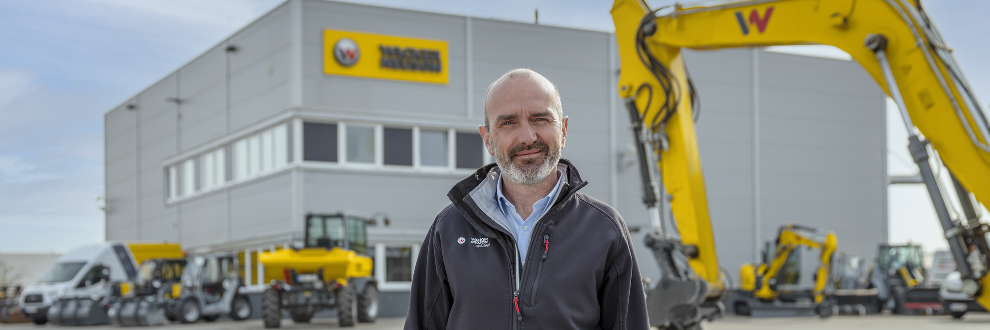 Wacker Neuson employee standing in front of Wacker Neuson rental station.