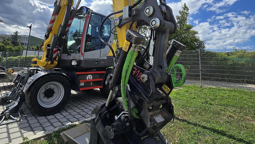 Excavator EW100 in action with blue sky in the backround 
