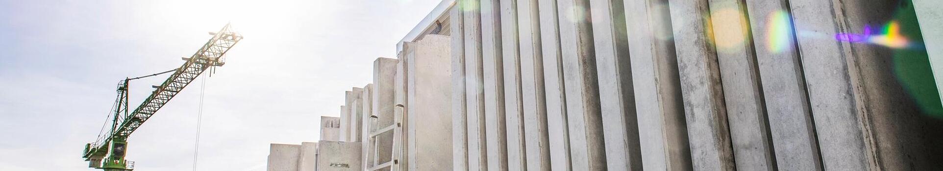 Concrete walls standing vertically on a construction site.
